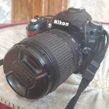 notbuk ucuz: Nikon D90 rəqəmsal güzgülü kamera. Kameranın qara rəngli korpusu var — 5