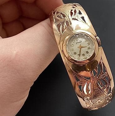 Kəmərlər: Qizil saat,583 eyyar. 24,4qram Temiz qızılının çekisi. Qedimi — 1