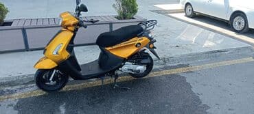 купить мопед в кредит: === PART 1: TEXTUAL DESCRIPTION === Sarı rəngli, müasir dizaynlı — 5