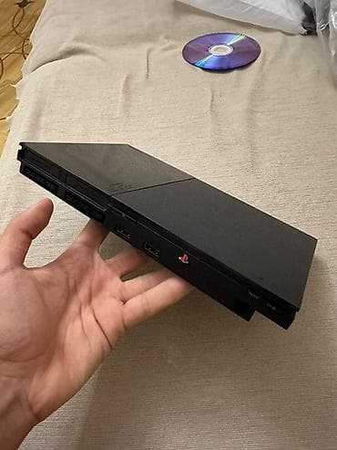 ps1 disk: PlayStation 2 Slim oyun konsolu. Kompakt və nazik korpusa malik PS2 — 1