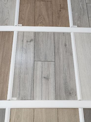 Laminat döşəmə panelləri – taxta teksturalı, müxtəlif rəng tonlarında