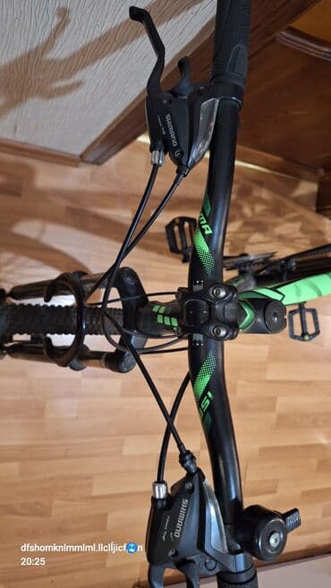 ktm velosipēdi: ISMA markalı, qara rəngli, yaşıl detalları olan dağ velosipedi — 8