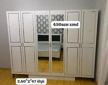 dola: Ağ rəngdə 6 qapılı paltar dolabı. Ön hissədə iki böyük güzgülü qapı — 1