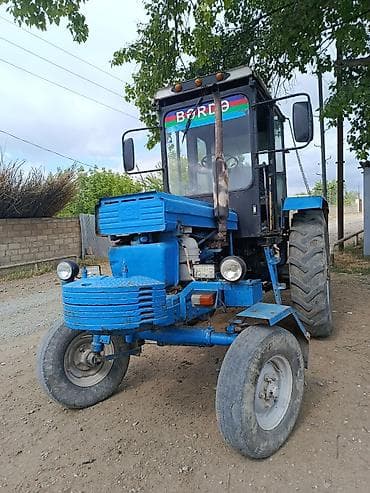 Mavi rəngli tək kabinəli təkərli traktor. Texniki xüsusiyyətlər və