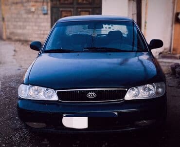 əllə çəkilmiş maşın şəkilləri: Kia Sephia sedan - Kuzov: 4 qapılı sedan, tünd yaşıl rəng - Ön hissə — 1