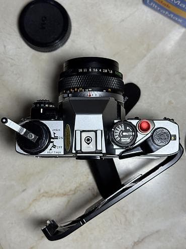 instax mini 12 en ucuz: 1979-cu il Yaponiya istehsalı. Olympus OM 10 35 mm film ilə işləyən — 2