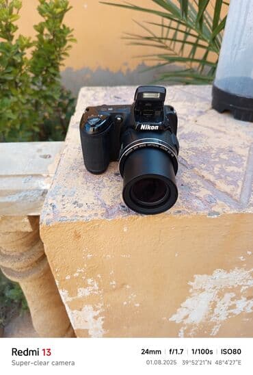 yemek bisiren aparat: Nikon brendinə məxsus qara rəngli fotoaparat, istifadəçilər üçün rahat — 1