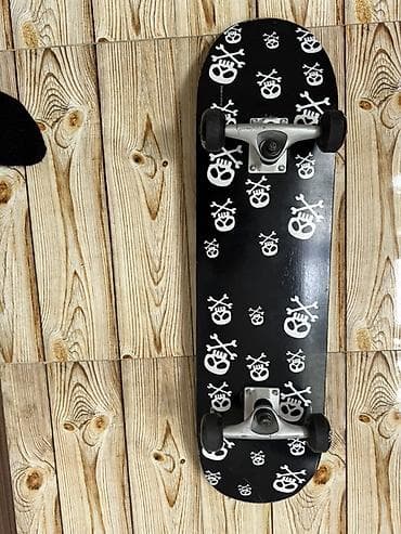 Skateboard – klassik ölçüdə, qara rəngli gövdə və ağ kəllə-sümük