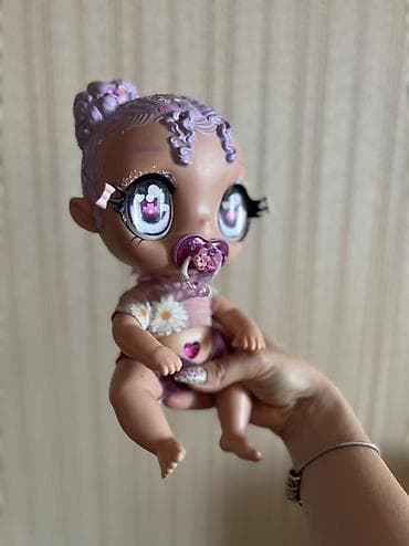 Kukla Glitter Babyz Lila MGA. Bu cazibədar kuklaların parlaq saçları