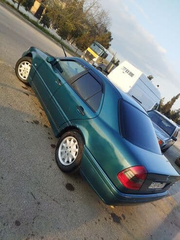 бампер на мерседес w210: Mercedes-Benz markalı, tünd firuzəyi rəngli sedan. Avtomobil rahat və — 3