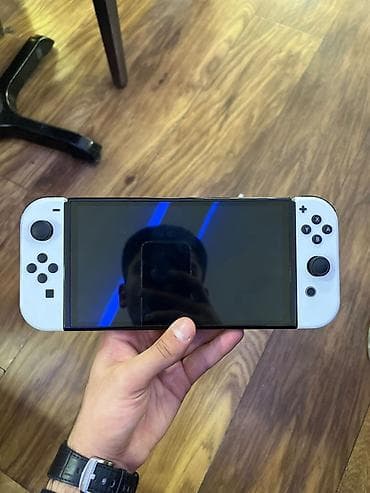 Nintendo Switch OLED (Ağ) Xüsusiyyətlər: - 7 düym OLED ekran – daha