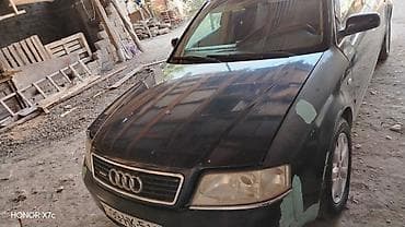 ucuz motolar: Audi A6 sedan təqdim olunur. Avtomobil tünd rəngdədir, 4 qapılı кузов — 4