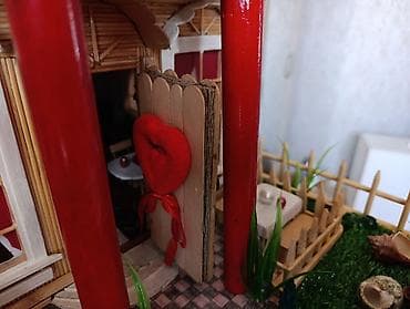 flo memar ecemi: Miniatür ev modeli, qırmızı damı və ətrafında hasarlı yaşıllığı ilə — 8