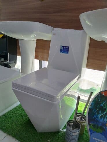 Ağ rəngdə, müasir dizaynlı unitaz. Bu unitaz hamam otağınıza zərif və