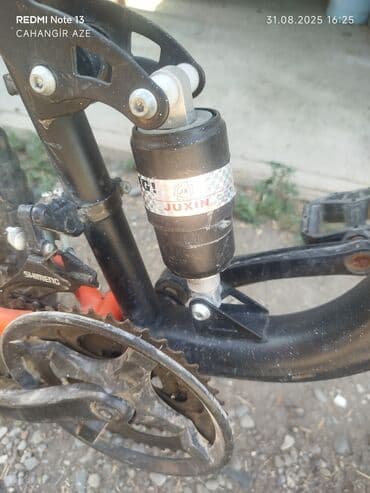 JUXIN amortizatorlu və Shimano komponentli, parlaq qara və narıncı