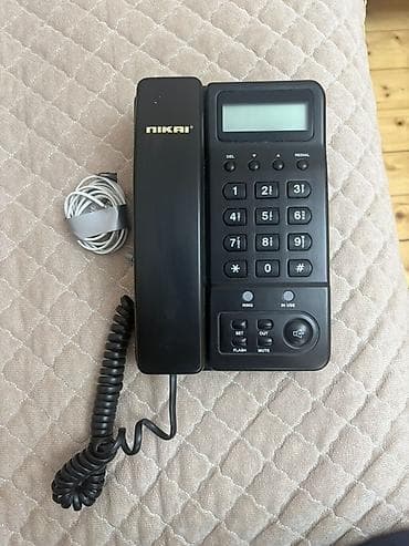 NIKAI markalı masaüstü simli telefon. Klassik qara rəngdədir və ev