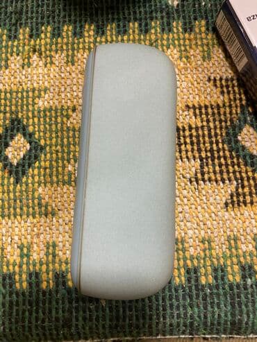 IQOS cihazı – mavi/boz çalarda, zərif dizayn. Xüsusiyyətlər: - Brend