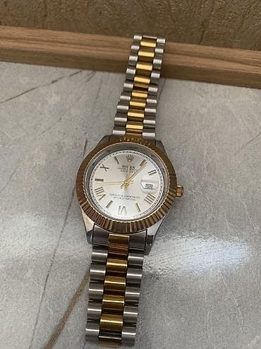 Salam rolex markasindan olan qol saati satiram, az islenib tezeden
