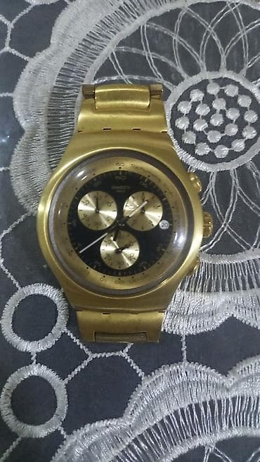 t800 saat: Swatch Irony qol saatı. Saat qızılı rəngli metal korpus və metal — 2