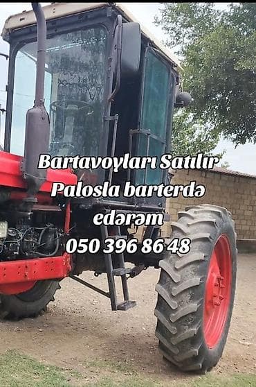Matorlu traktor. Kabinəli, ön və arxa iri kənd təsərrüfatı təkərləri