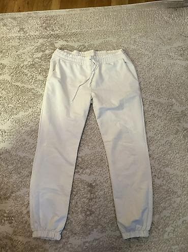 These are white jogger-style pants. They feature an elastic waistband — 1