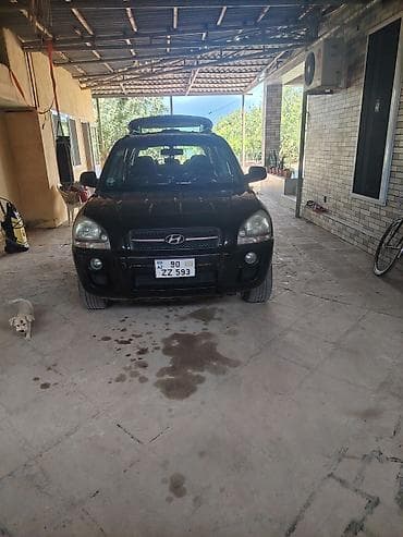 larzon disk: Hyundai Tucson CRDi – dizel, avtomat, qara rəngli kompakt SUV. Əsas — 4