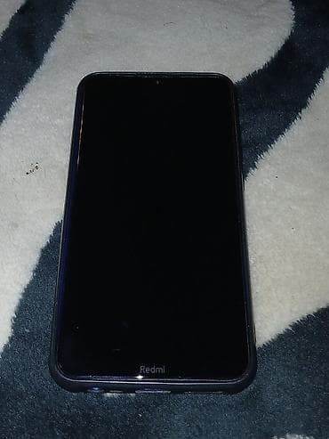 nokia 65 00: Mavi rəngdə sadə və yüngül mobil telefon. Arxa qapaqda mərkəzdə uzanan — 2