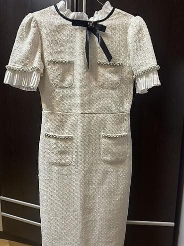 Ağ tüvit materialdan, klassik siluetli midi don. Brend: Julidress