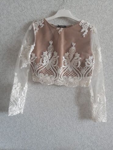 yupqa kofta: Naxışlı ağ krujeva detalları olan bej rəngli qısa kofta. 34 razmerə — 1