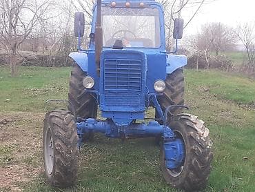 Mavi rəngdə kabinəli kənd təsərrüfatı traktoru. Xüsusiyyətlər: -