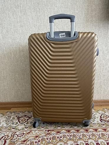 LODE brendinin qızılı rəngdə sərt korpuslu səyahət çamadanı L razmer