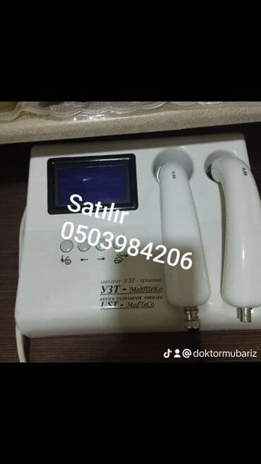 Ağ rəngli, MedTeKo markalı ultrasəs terapiya cihazı. Cihaz kosmetik