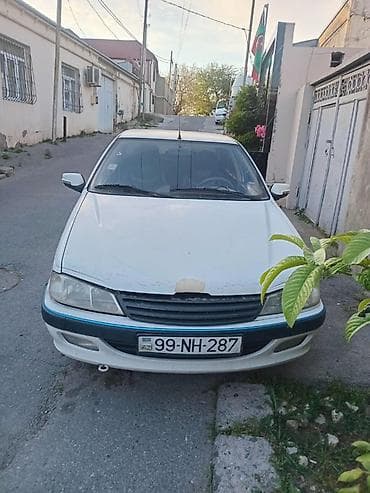 ehtiyat təkəri: Peugeot Pars sedan – ağ rəng, 4 qapı, öndən‑çəkişli. Xüsusiyyətlər: - — 3