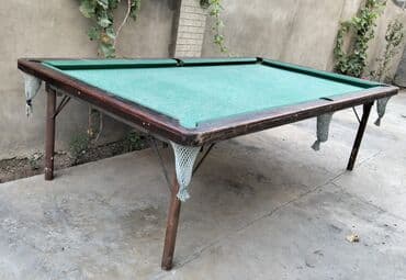 Taxta karkaslı və yaşıl bilardo səthi olan klassik bilyard stolu. Bu