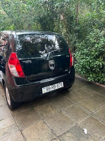 kia optima 2019: Arxa tərəfində "i10" yazısı olan qara rəngli Hyundai i10 modeli — 2