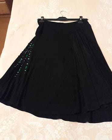 boy uzadan: Zərif qara ətək, yaşıl bəzək detalları ilə vurğulanmışdır. Bu ətək — 2