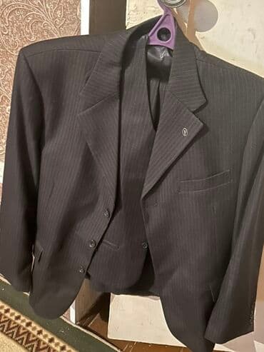 Qara rəngli, zolaqlı, üç hissədən ibarət kostyum. Kostyum, pencək və