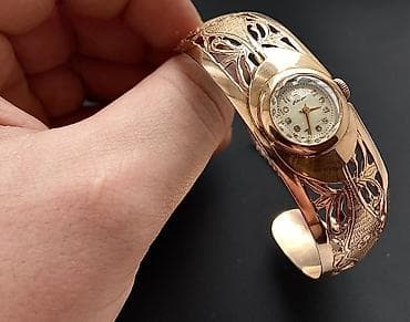 Kəmərlər: Qizil saat,583 eyyar. 24,4qram Temiz qızılının çekisi. Qedimi — 2