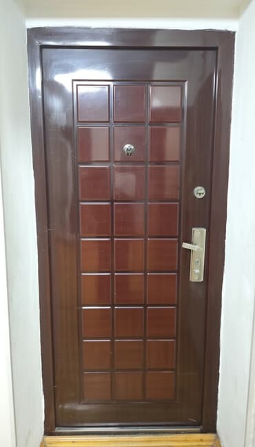 - Giriş qapısı: Tünd qəhvəyi tonlarda metal karkaslı dekorativ panelli