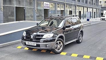 qara maşın: Mitsubishi Outlander – şəhər və yolsuzluq üçün praktik krossover. - — 2