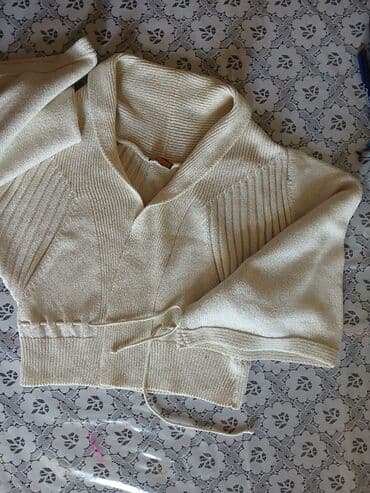 Açıq bej rəngli, qısa kəsimli qadın kardiganı. Geniş yaxalıq və enli