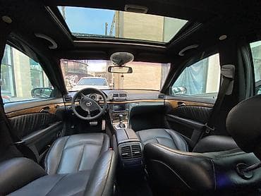 mercedes c190: Mercedes-Benz E‑Class (W211) sedan – qara rəng, AMG üslublu eksteryer — 6