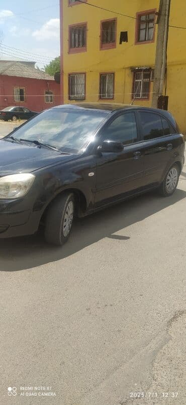 последующий выкуп авто бишкеке: Qara rəngdə olan Kia Rio avtomobili. Bu model şəhər daxilində rahat — 10