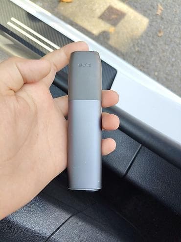IQOS ILUMA ONE tütün qızdırma cihazı, tünd boz rəngdə və kompakt, oval — 2