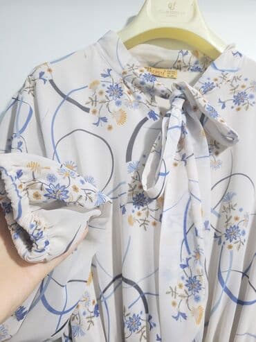 xari bulbul simvolu: Ağ rəngli, çiçək naxışlı don. Boyun hissəsində bağlanan lenti var — 1