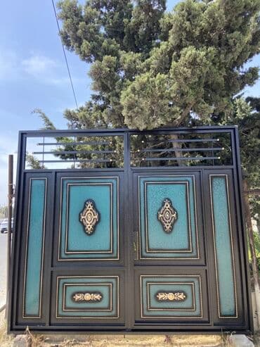 demir qapi bezekleri: Qara rəngdə, bürünc elementlərlə bəzədilmiş metal qapı. Qapının — 1