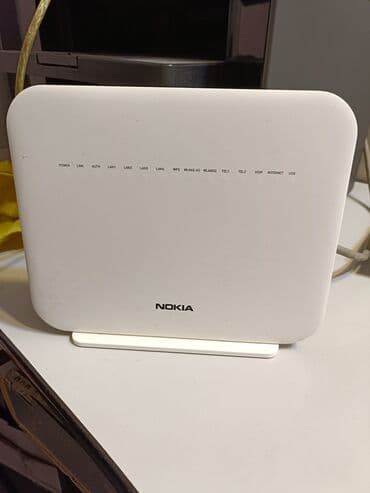 Modemlər və şəbəkə avadanlıqları: Nokia markalı ağ rəngli simsız router. Bu kompakt cihaz evdə və ya — 1