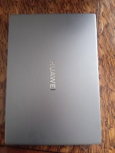 Huawei: Huawei noutbuk – metalik boz gövdə, nazik və yüngül dizayn. Üst — 1