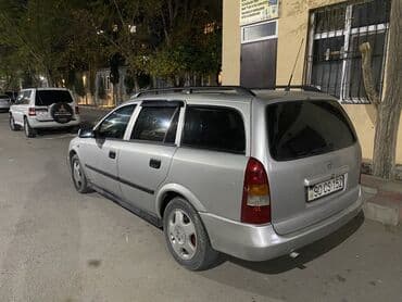 чемодан с инструментами для автомобиля: Opel Astra Caravan (universaI) – gümüşü rəngdə, 5 qapılı ailə və yük — 1