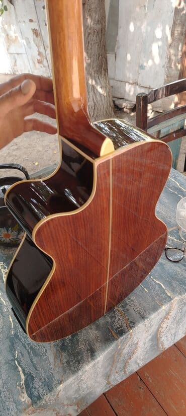 гитара со звукоснимателем: Bu akustik gitara tünd qəhvəyi rəngli taxta korpusa malikdir. Gitara — 2